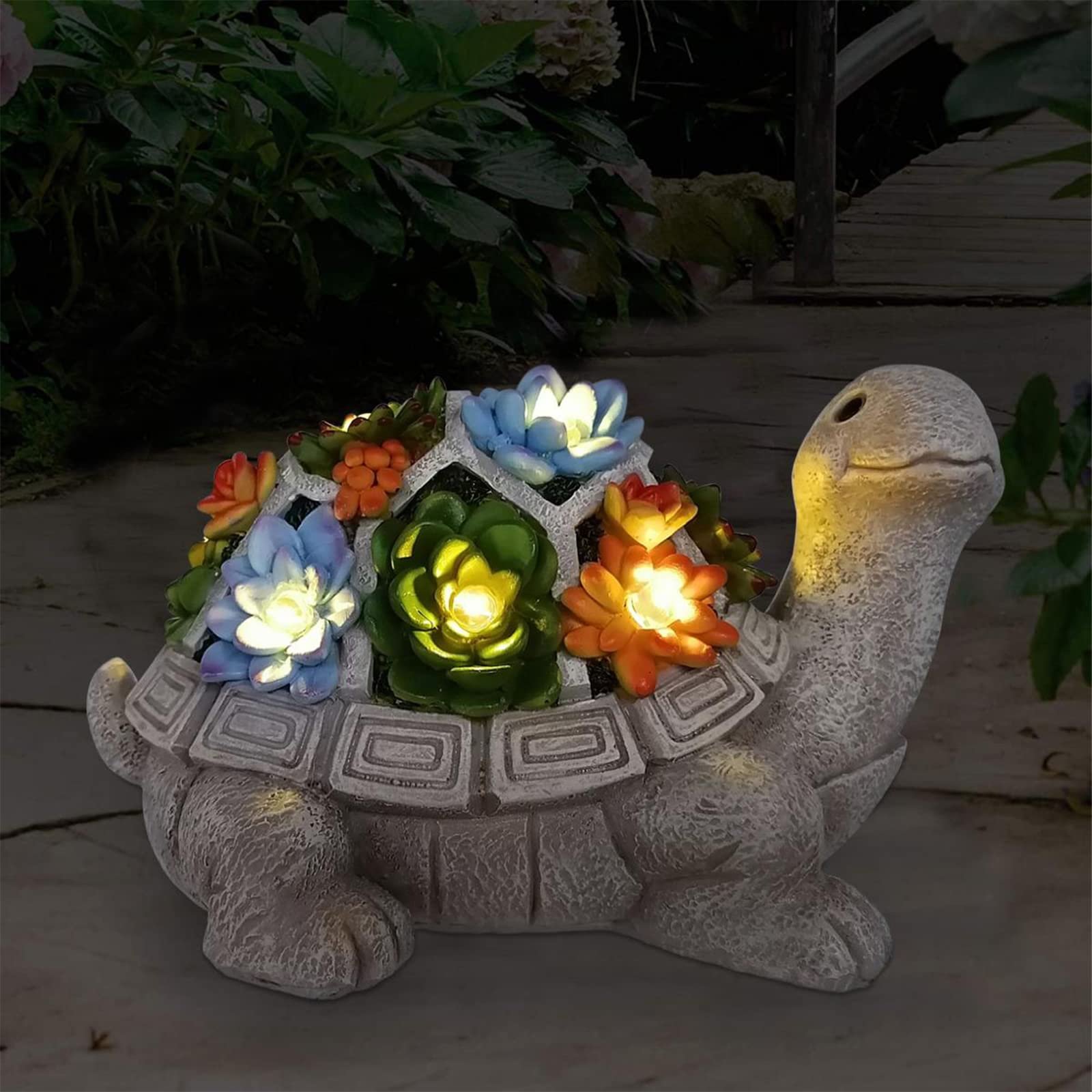 Stone turtle statue with solar-powered, glowing succulent plants on its back